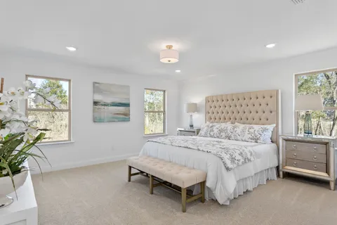 a bathroom with a sink double vanity granite tub shower and a mirror