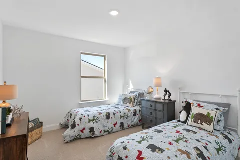 a living room with furniture a flat screen tv and windows