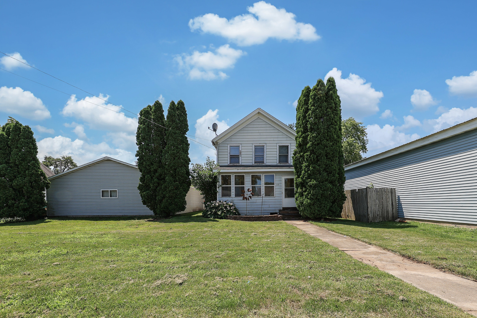a view of a house with a garden and yard