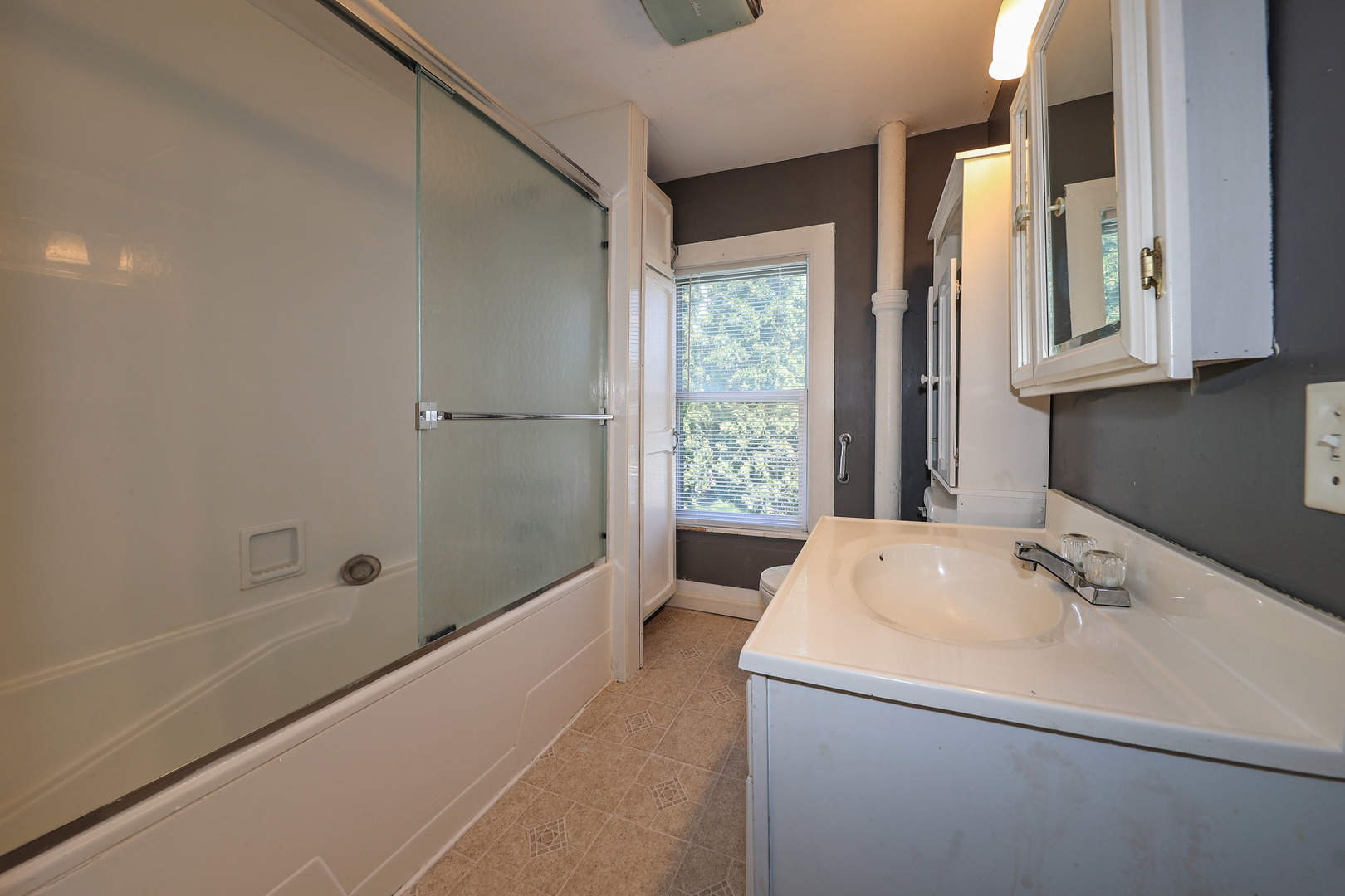 115 North Main Street Seneca, IL 61360 - Photo 12 of 17 a bathroom with a sink a mirror and a bathtub