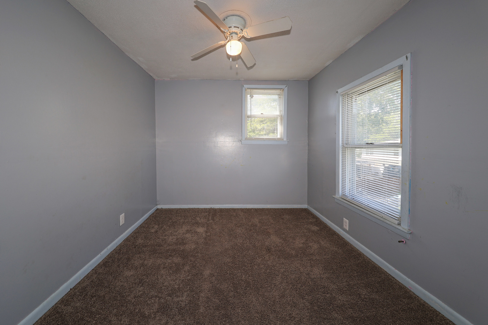 115 North Main Street Seneca, IL 61360 - Photo 15 of 17 an empty room with a window and a fan
