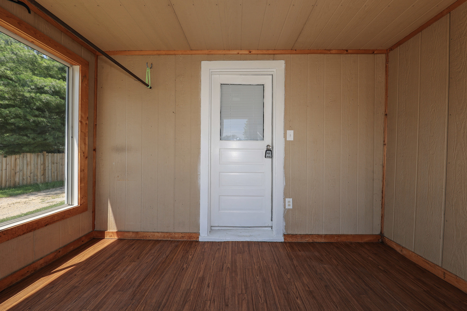 115 North Main Street Seneca, IL 61360 - Photo 3 of 17 a view of an empty room with wooden floor and a window