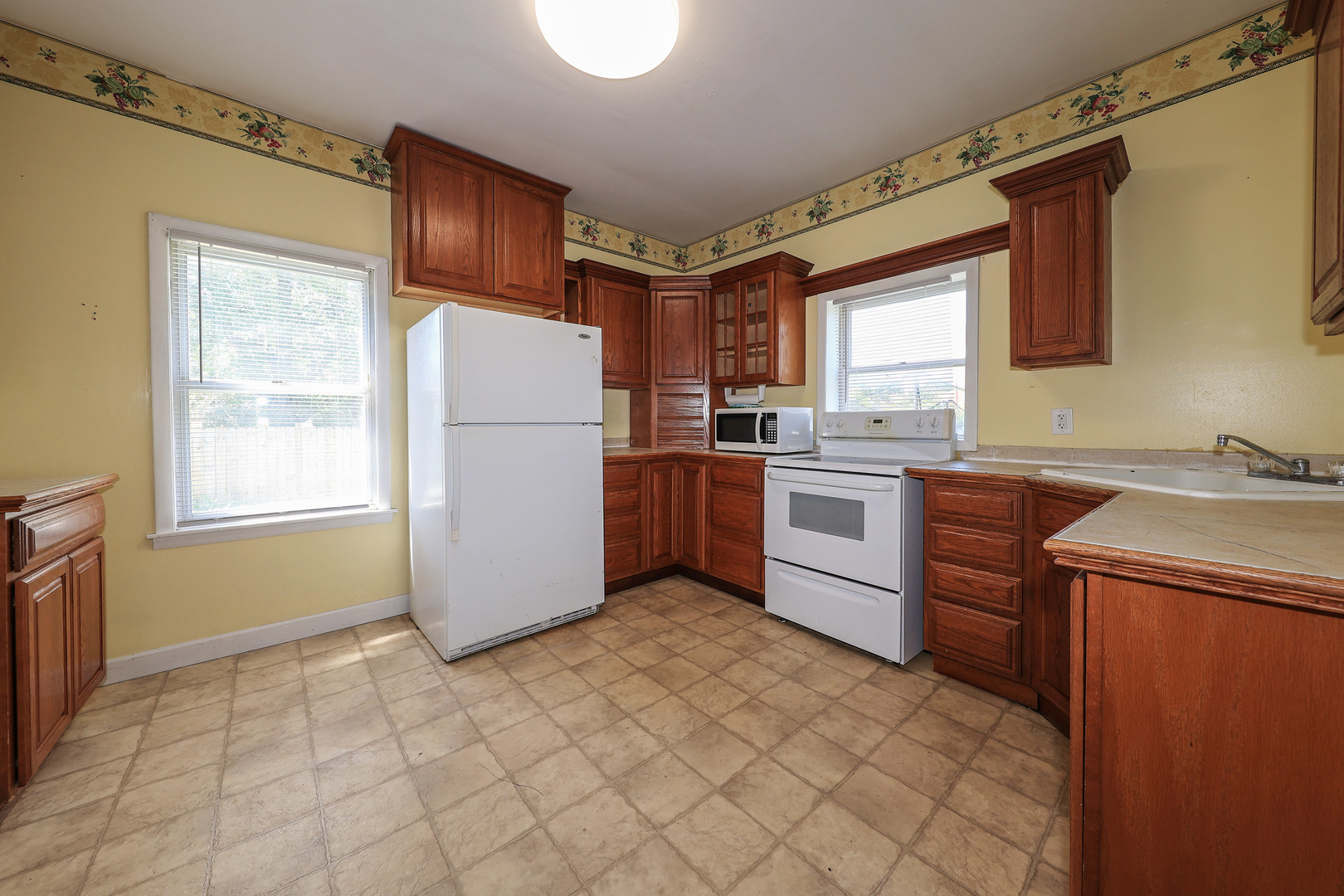 115 North Main Street Seneca, IL 61360 - Photo 4 of 17 a kitchen with a stove a refrigerator and a sink