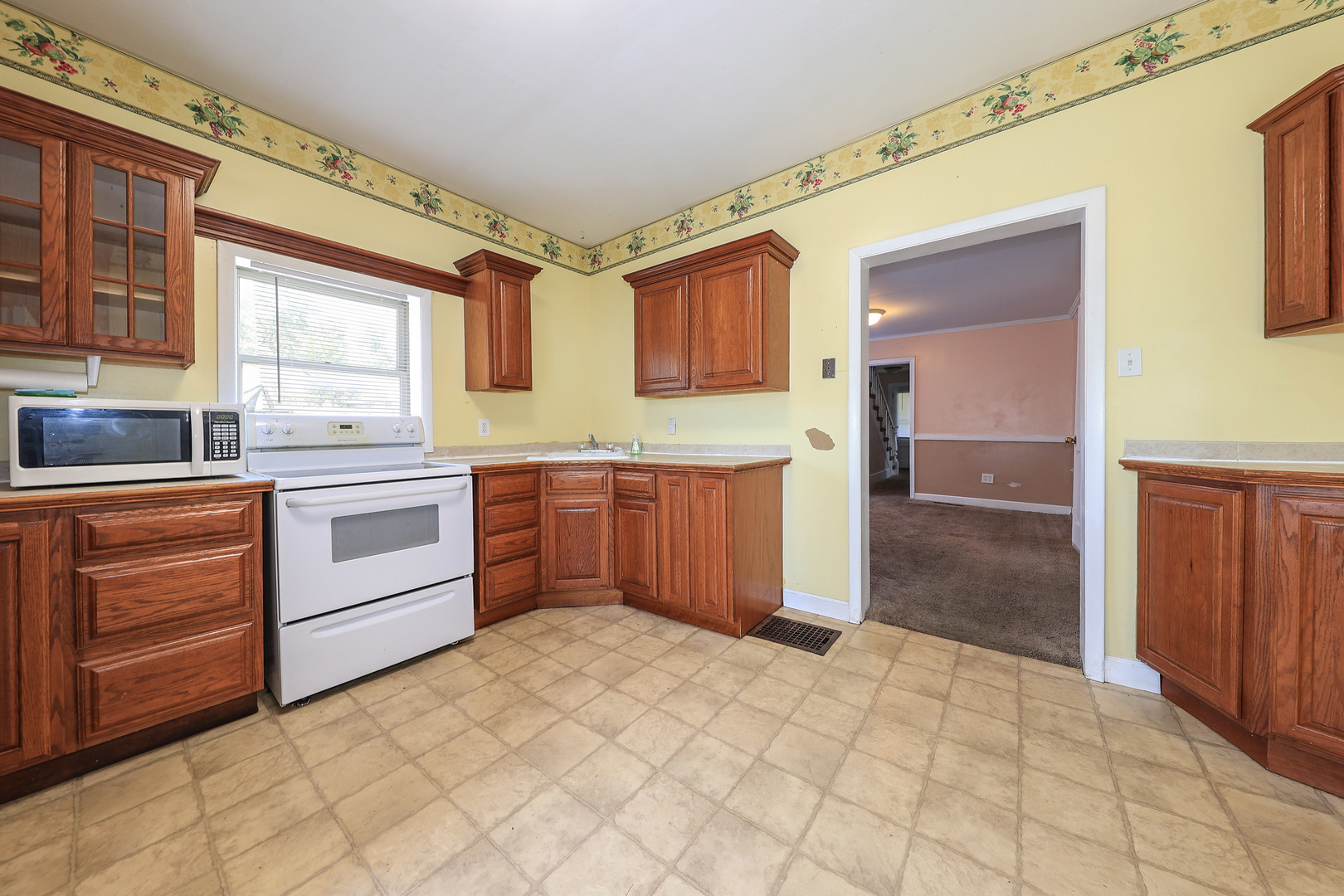 115 North Main Street Seneca, IL 61360 - Photo 5 of 17 a kitchen with a stove sink and cabinets