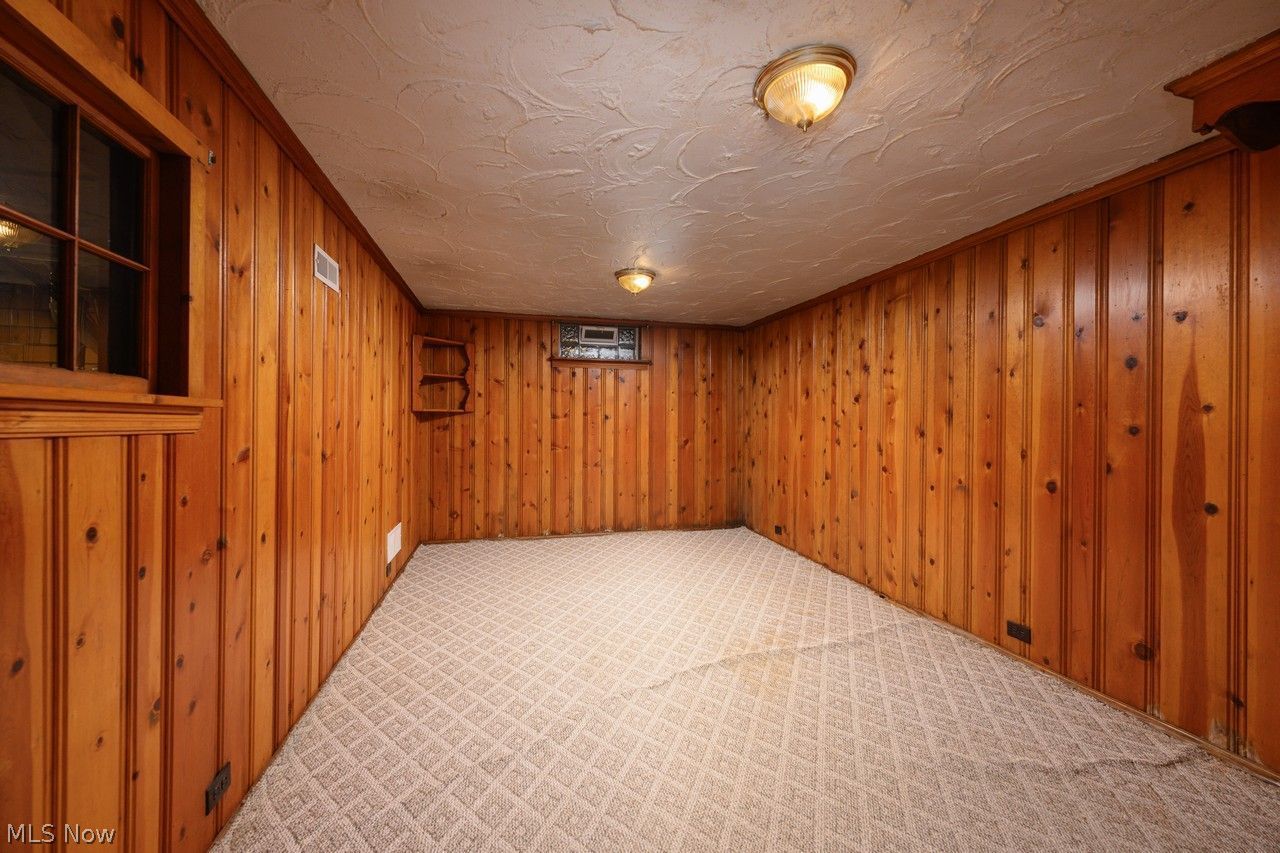 1422 Monument Road Northwest Canton, OH 44703 - Photo 19 of 31 Lower level rec room with knotty pine walls