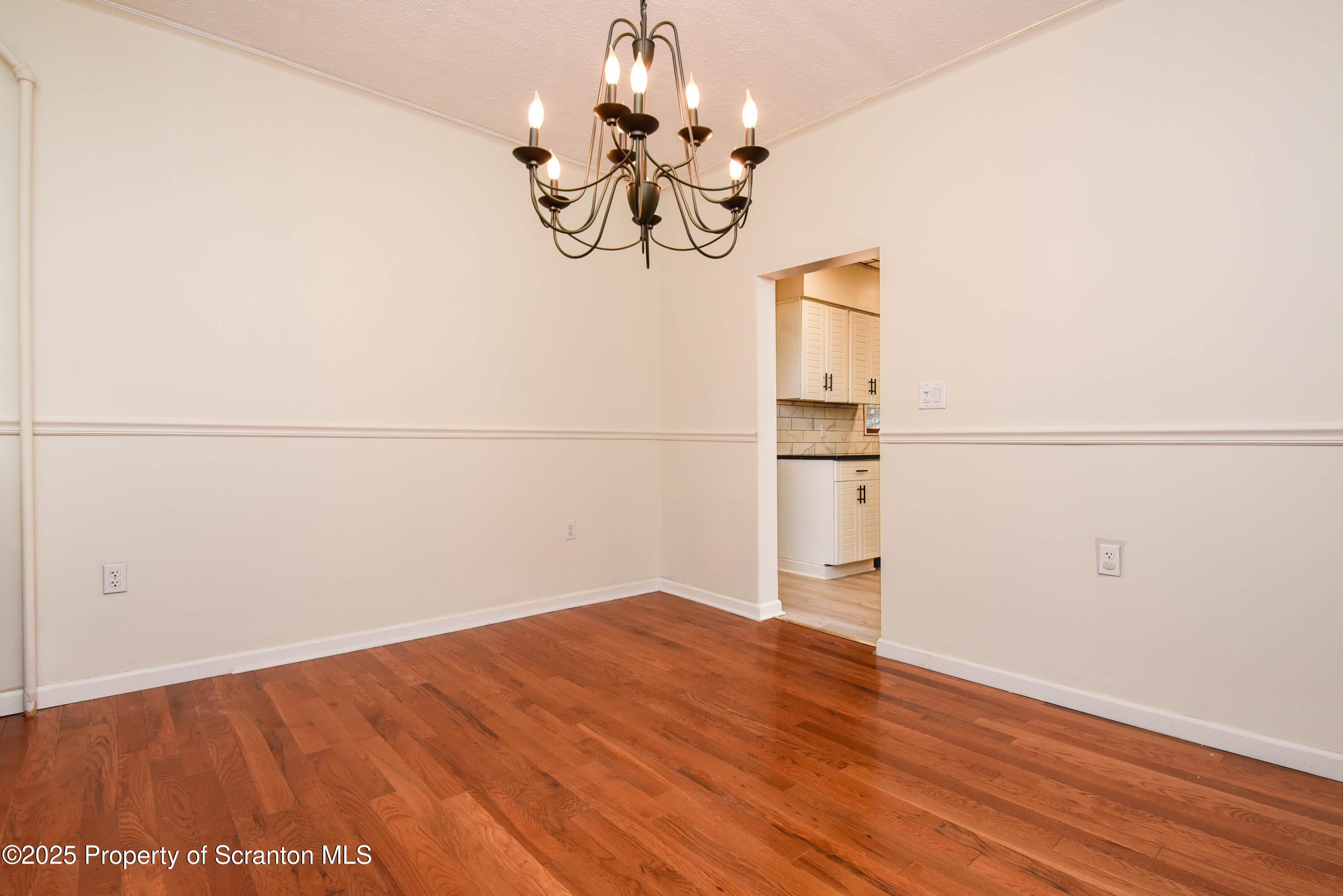 917 Taylor Avenue Scranton, PA 18510 - Photo 11 of 43 an empty room with wooden floor and mirror