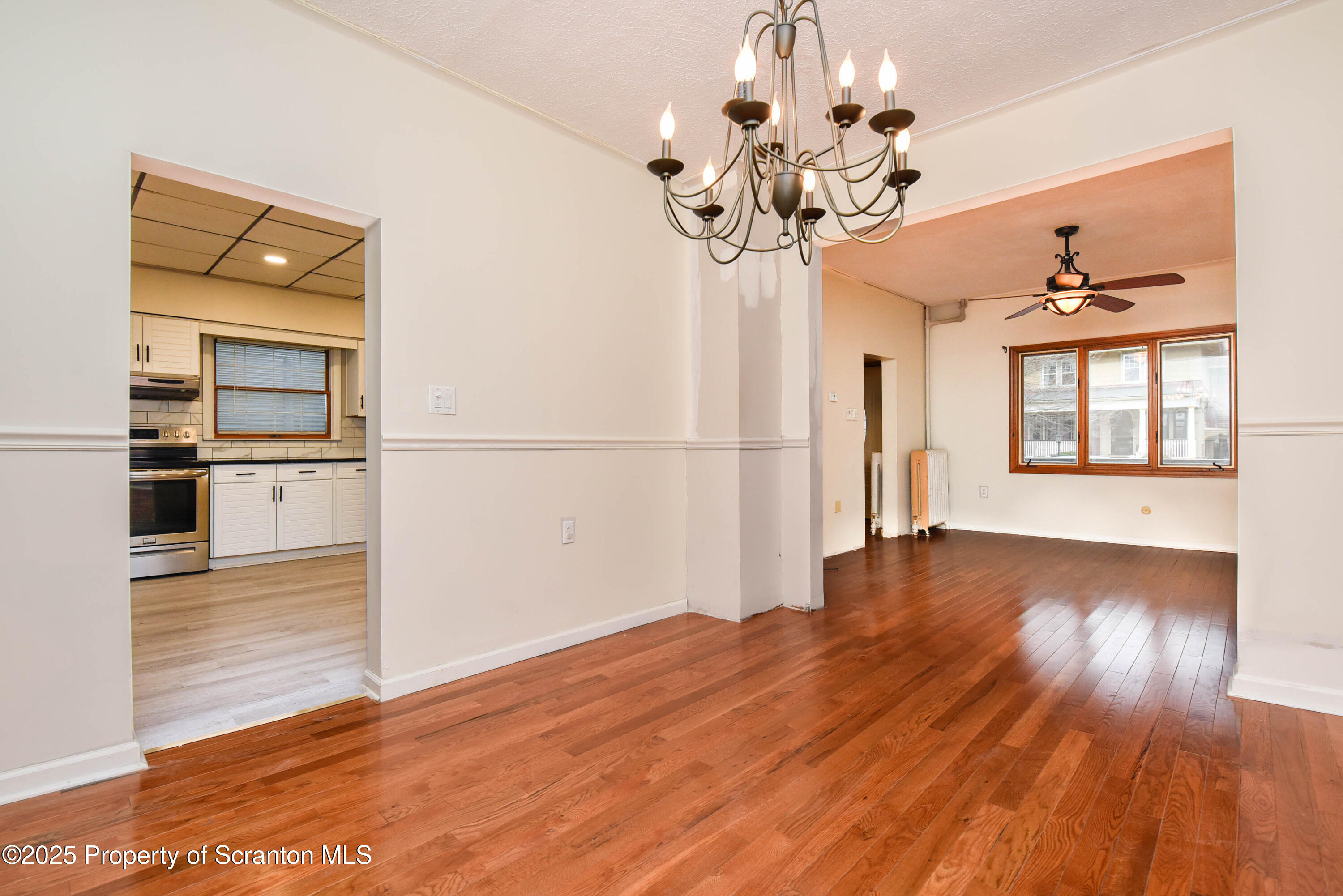 917 Taylor Avenue Scranton, PA 18510 - Photo 12 of 43 a view of a livingroom with wooden floor and a kitchen space
