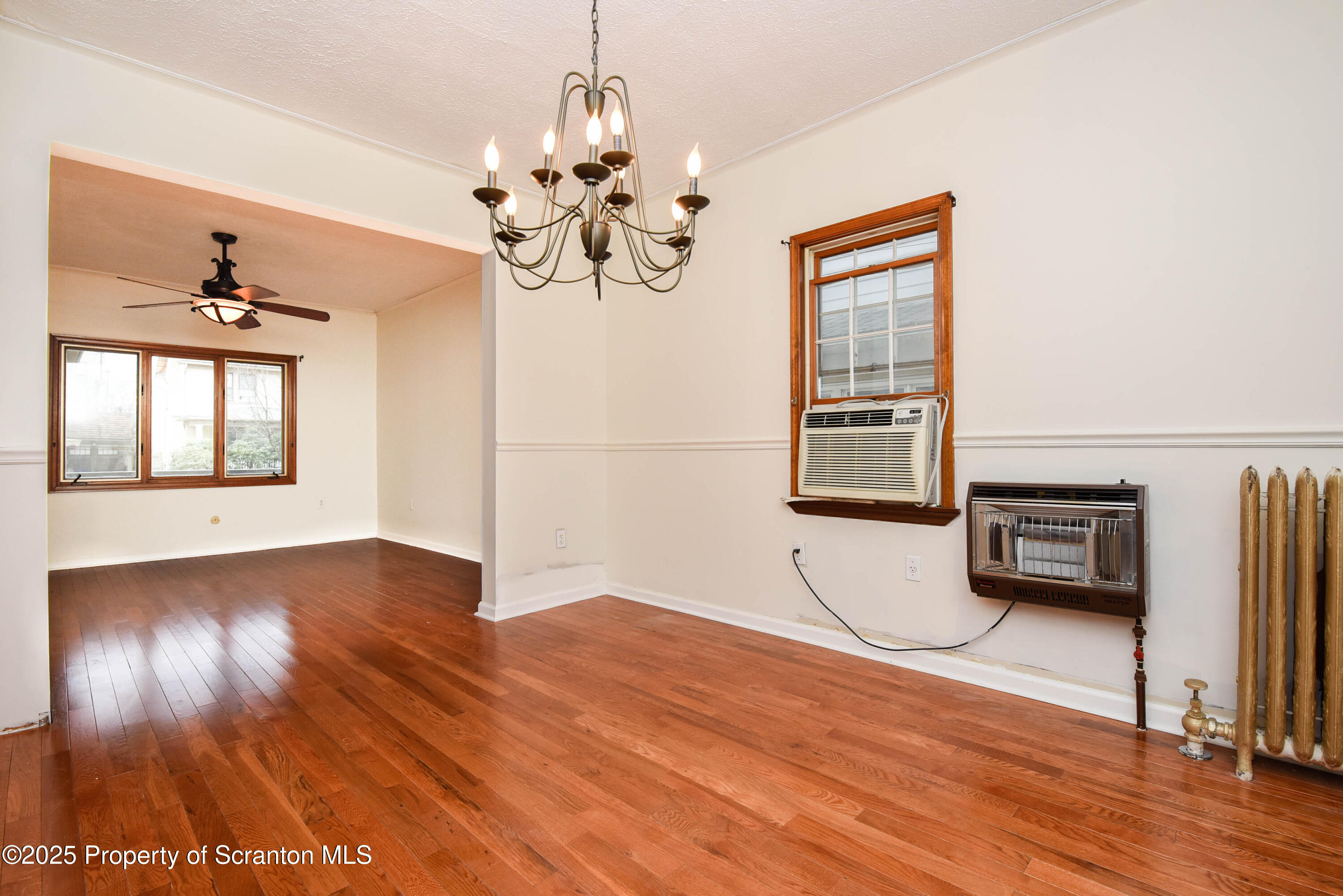 917 Taylor Avenue Scranton, PA 18510 - Photo 13 of 43 a view of an empty room with a window and wooden floor