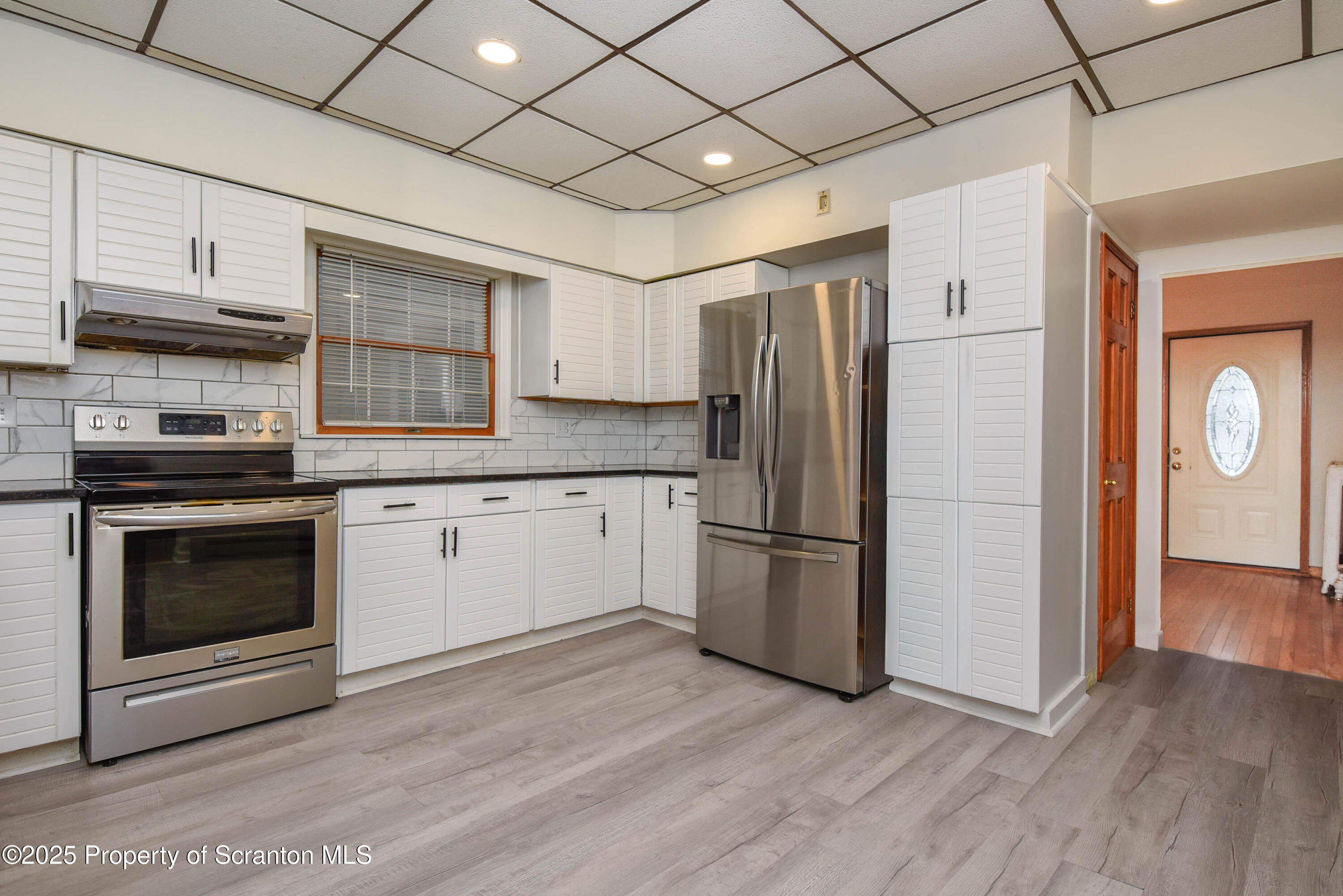 917 Taylor Avenue Scranton, PA 18510 - Photo 16 of 43 a kitchen with a refrigerator and a stove top oven