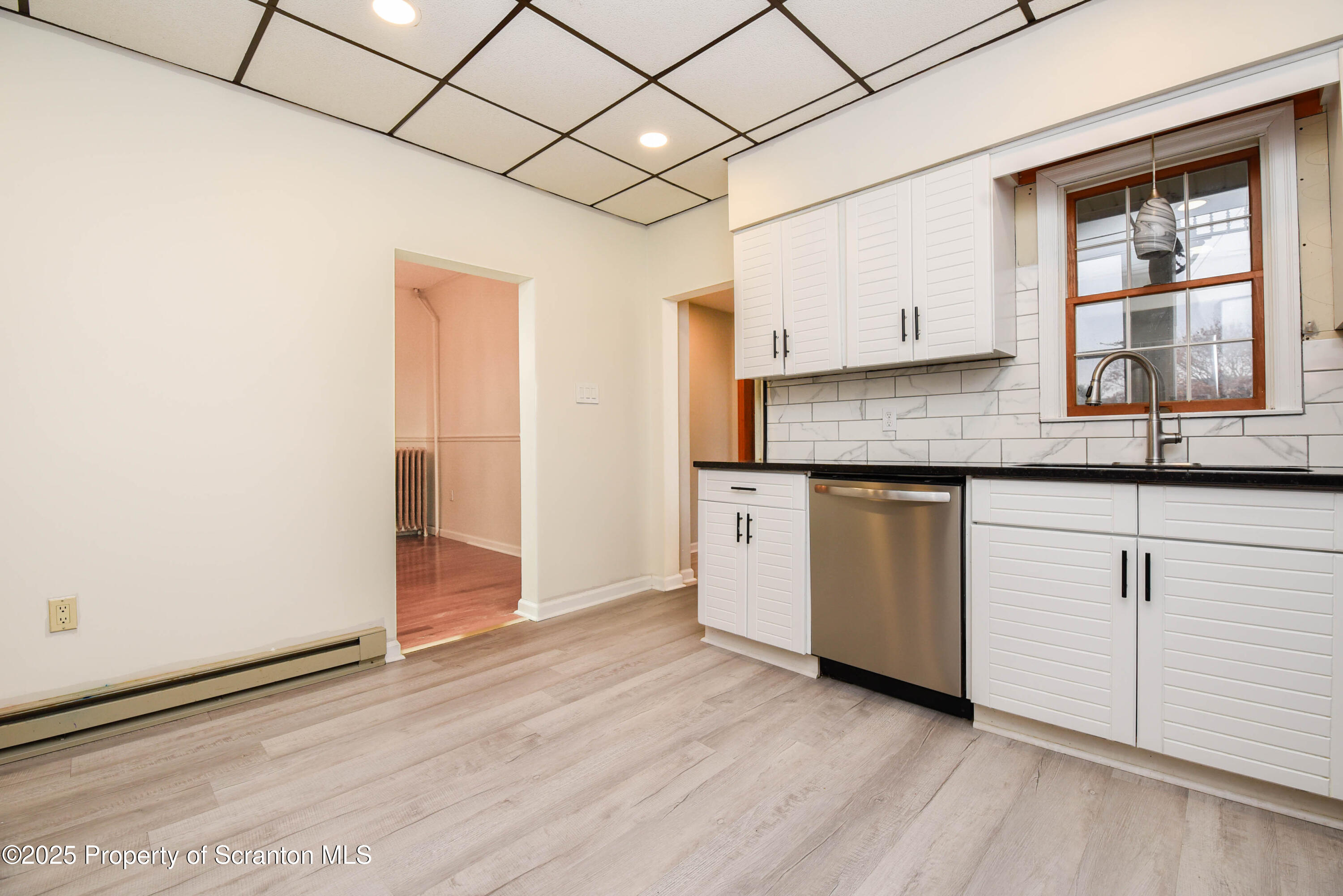 917 Taylor Avenue Scranton, PA 18510 - Photo 17 of 44 a kitchen with granite countertop white cabinets and white appliances
