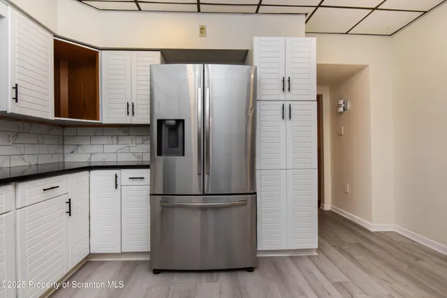 a kitchen with a refrigerator and a sink