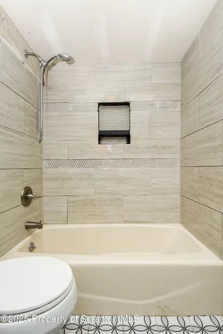 a bathroom with a white tub and a shower