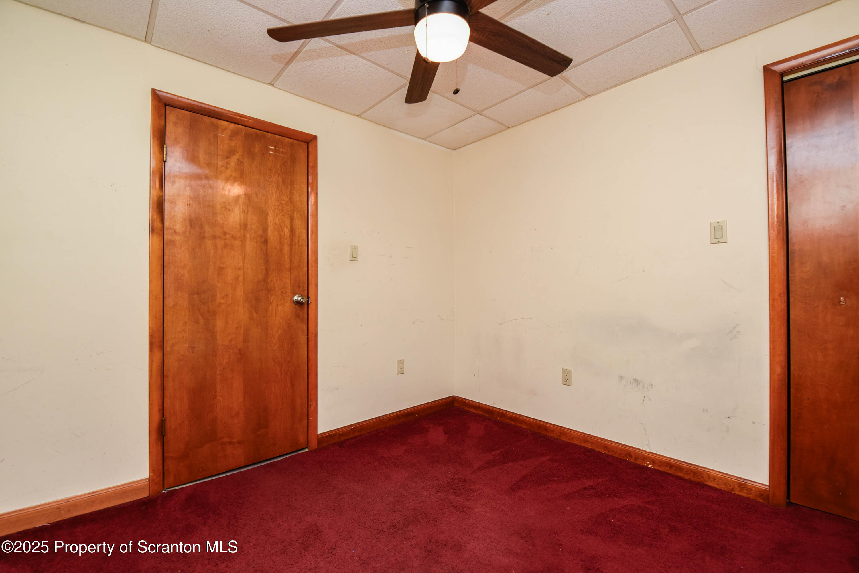 917 Taylor Avenue Scranton, PA 18510 - Photo 36 of 43 an empty room with a ceiling fan and carpet