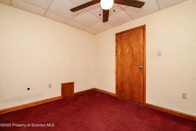 an empty room with a empty space and a ceiling fan