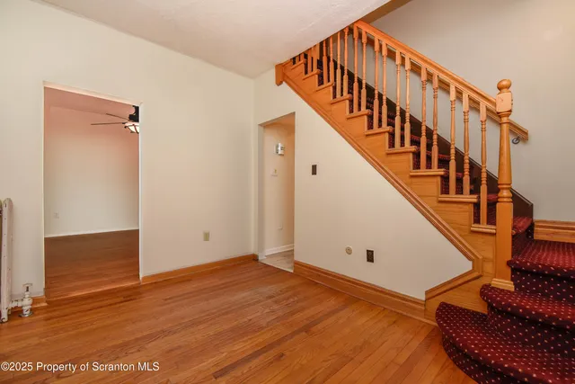 a view of an entryway with wooden floor
