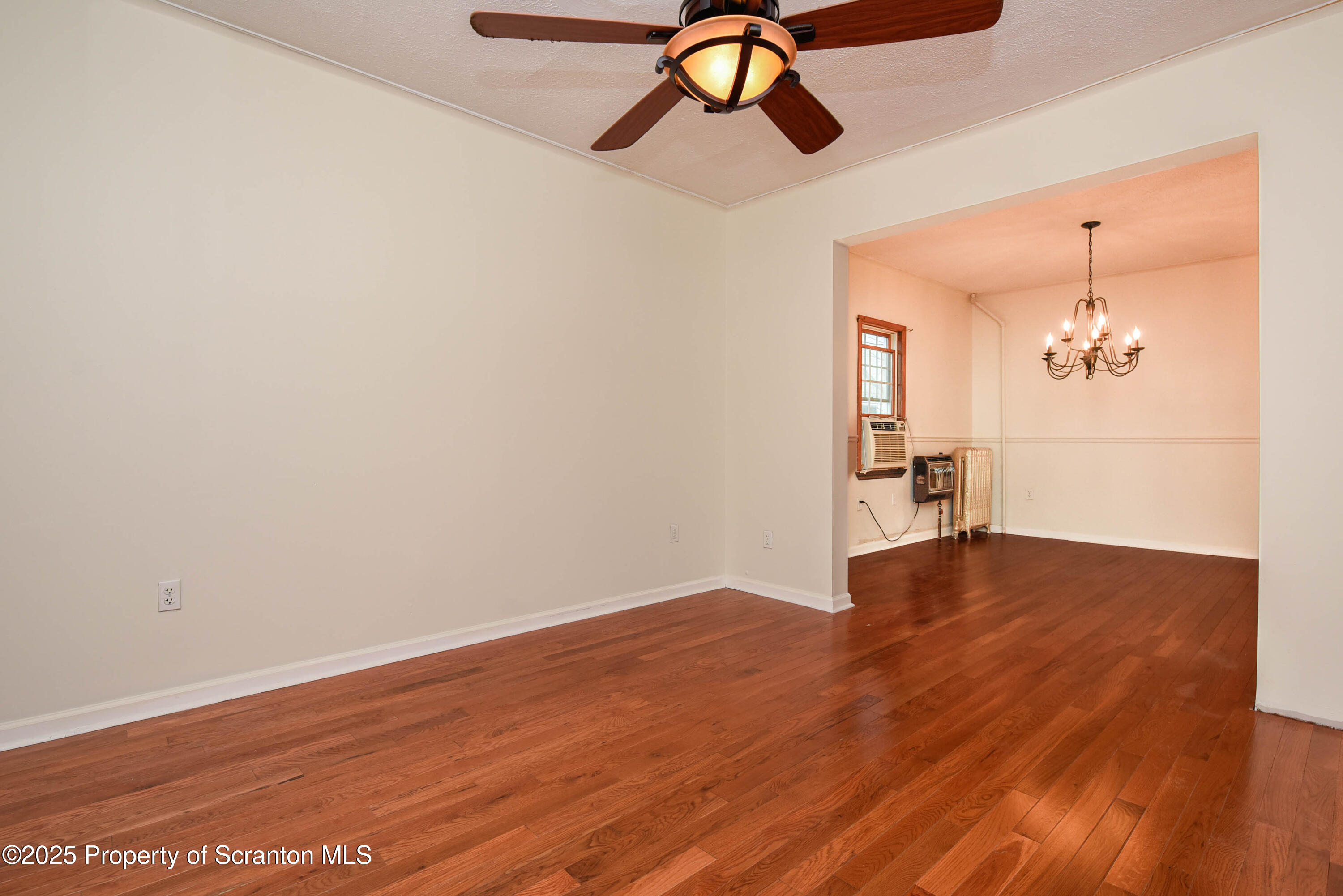 917 Taylor Avenue Scranton, PA 18510 - Photo 7 of 43 a view of a room with wooden floor staircase and a chandelier