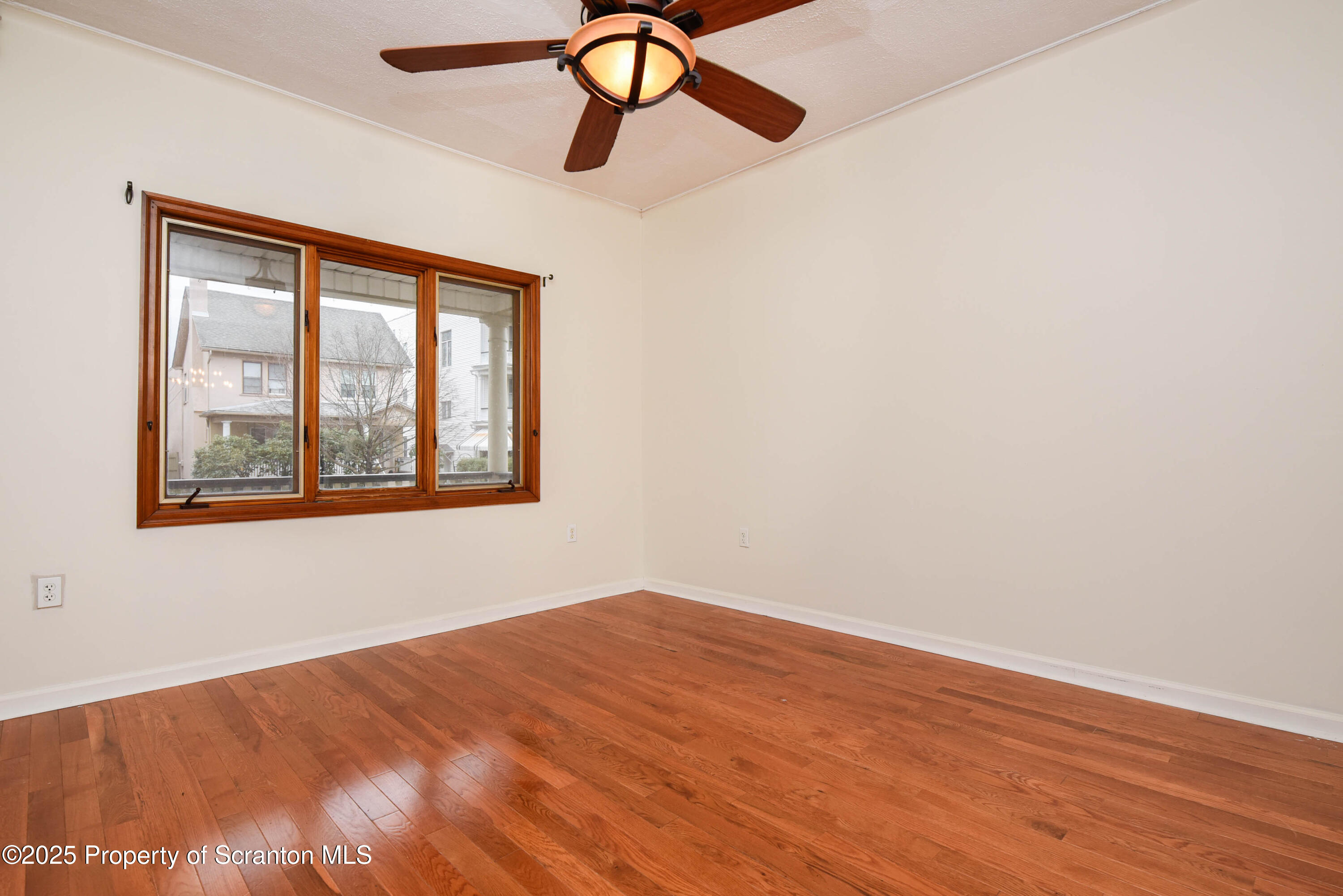 917 Taylor Avenue Scranton, PA 18510 - Photo 9 of 43 a view of a room with a large window and a ceiling fan