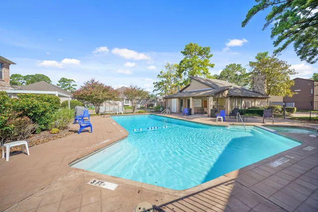 swimming pool view with a seating space and a garden view