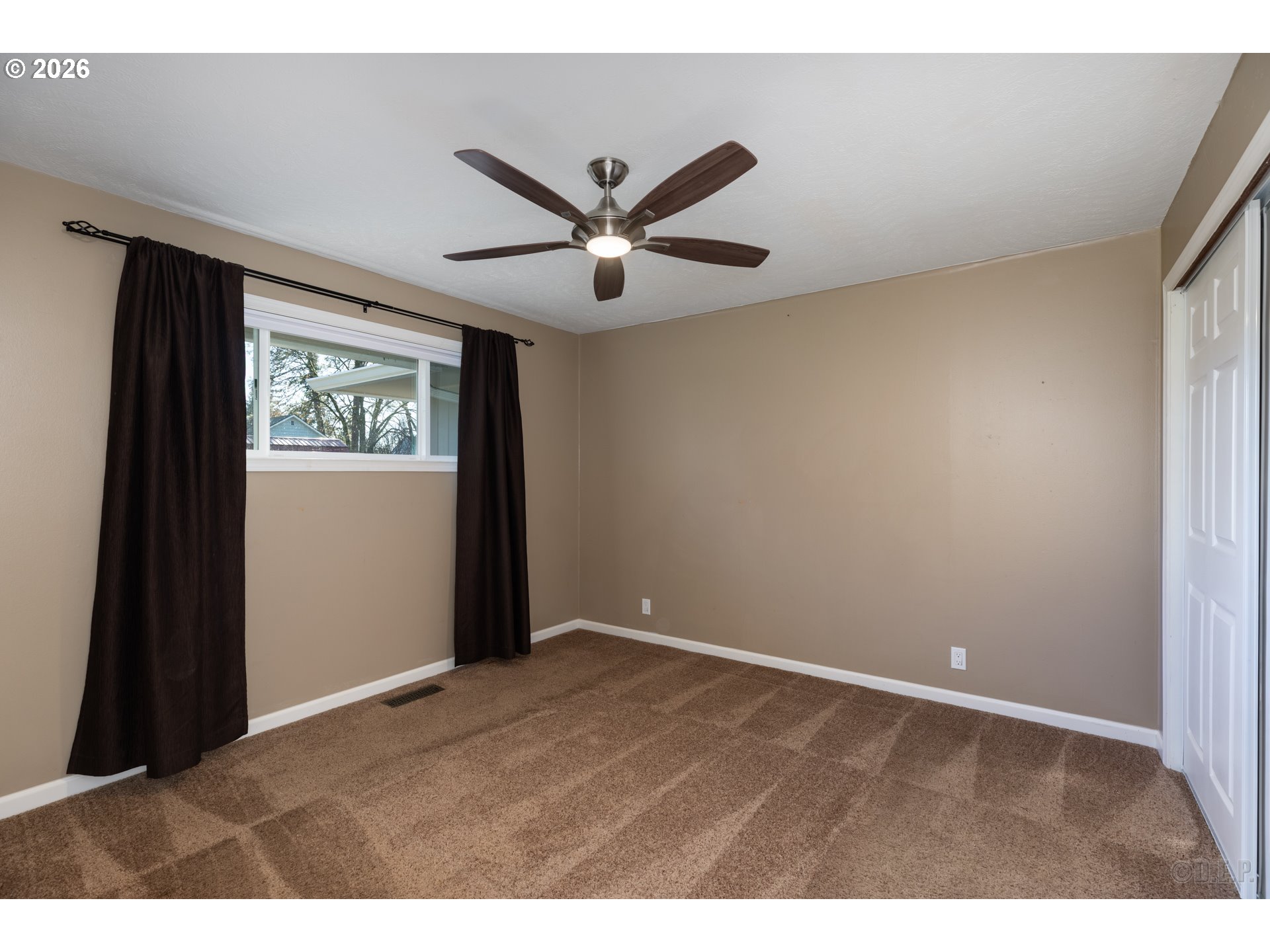 154 Michael Avenue St. Helens, OR 97051 - Photo 13 of 28 a view of an empty room with window and ceiling fan