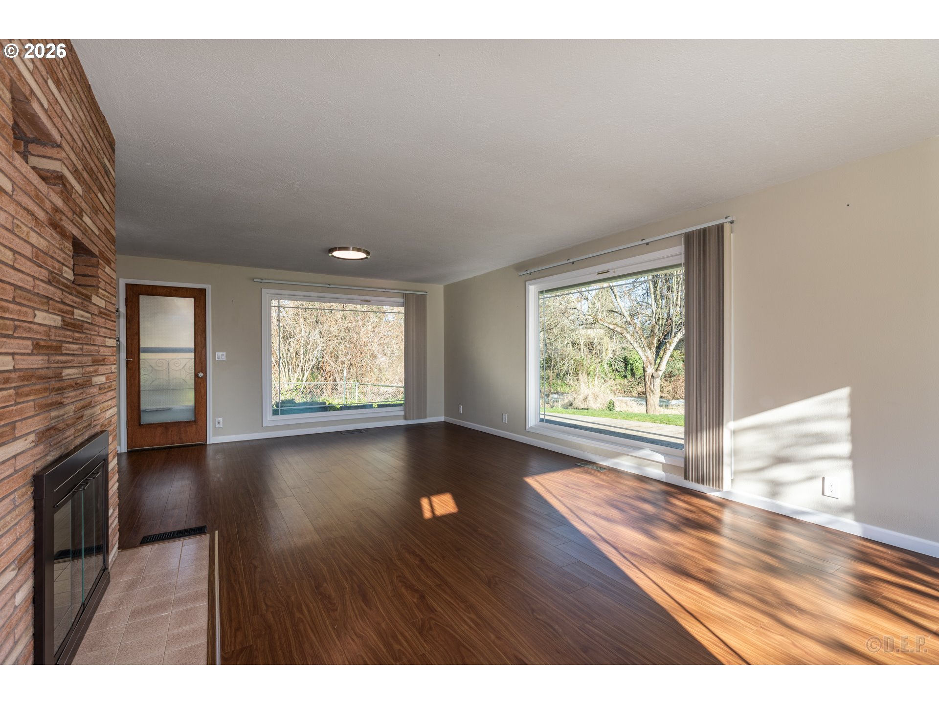 154 Michael Avenue St. Helens, OR 97051 - Photo 3 of 28 an empty room with wooden floor and windows