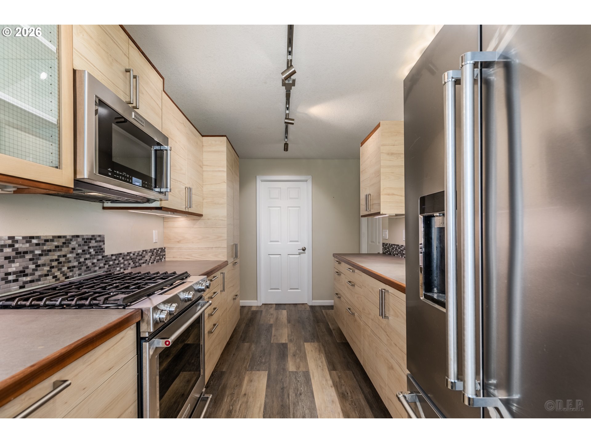 154 Michael Avenue St. Helens, OR 97051 - Photo 10 of 28 a kitchen with stainless steel appliances granite countertop a stove top oven a refrigerator and a microwave
