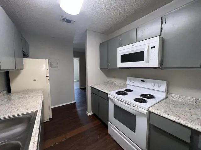 a kitchen with a stove and a microwave