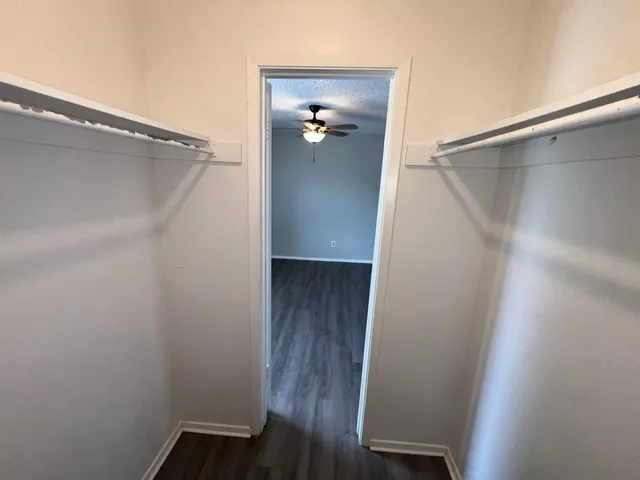 a view of a hallway with wooden floor