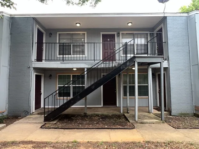 a view of a house with wooden walls and windows