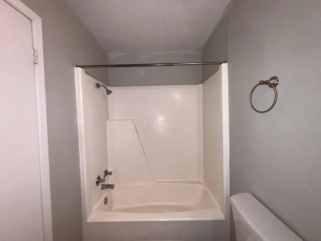 a bathroom with a shower and a bath tub