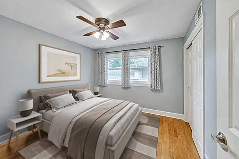 a bedroom with a large bed and a window
