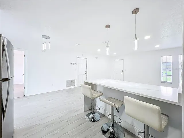 a large white kitchen with a large window
