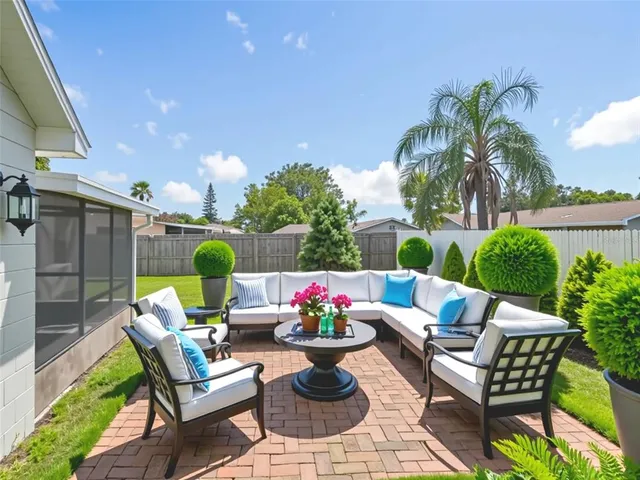 a view of a patio with couches and potted plants
