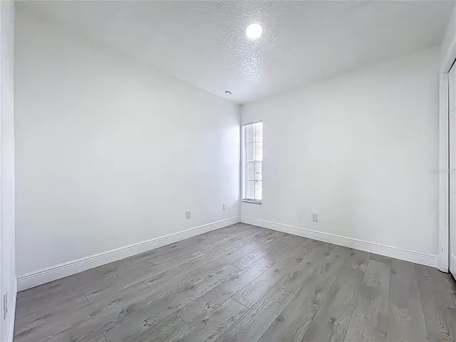 a view of room with wooden floor and window