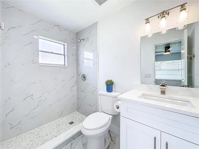 a bathroom with a sink toilet and shower