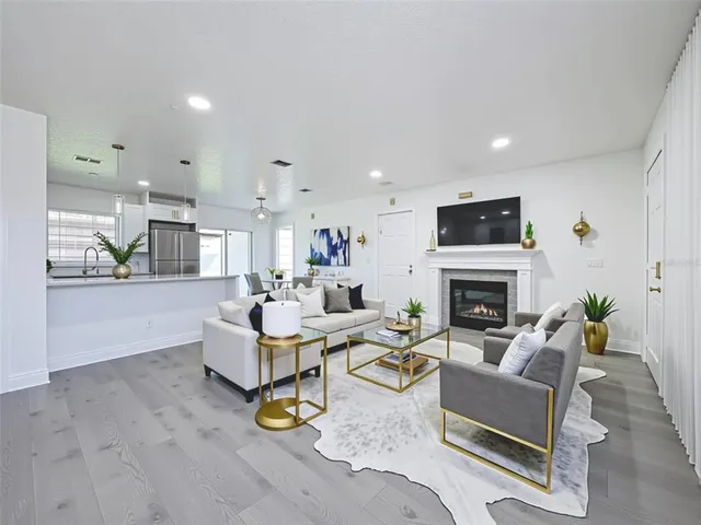 a living room with furniture a fireplace and a flat screen tv