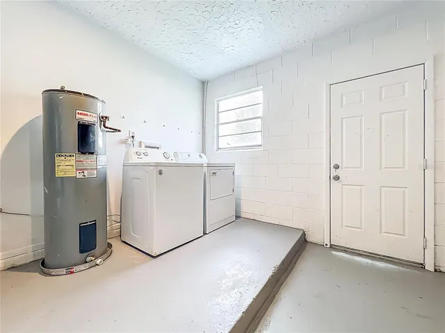 a view of kitchen with furniture and refrigerator