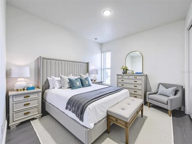 a bedroom with a bed and a couch