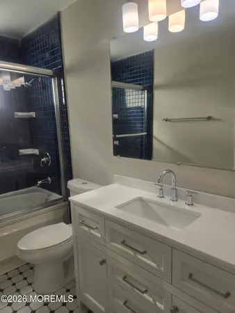 a bathroom with a toilet a sink and shower