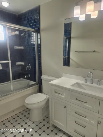a bathroom with a toilet a sink and shower