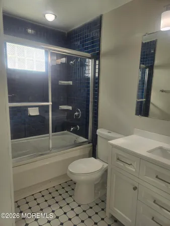 a view of a small space with wooden floor and a window