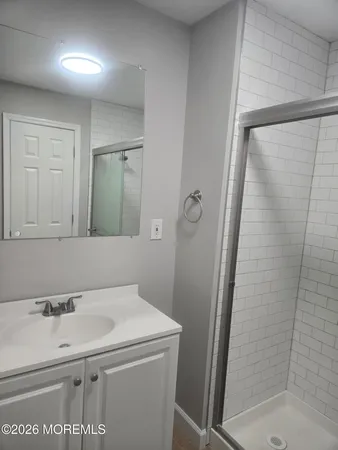 a white toilet sitting next to a shower