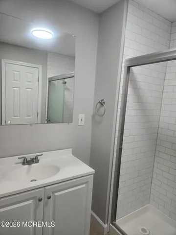 a white toilet sitting next to a shower