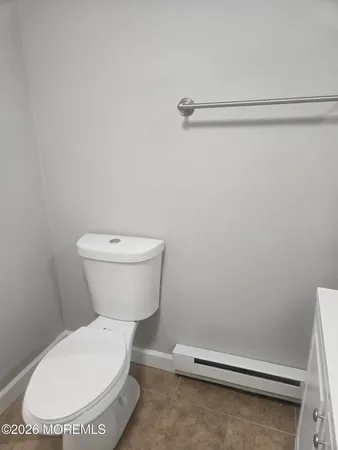 a view of empty room with window and wooden floor