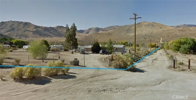 an aerial view of a house with a mountain