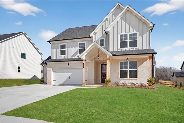 a view of a white house with yard and plants