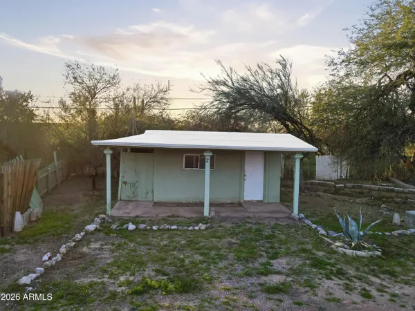 a backyard of a house with large trees