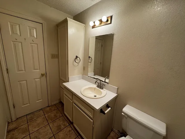 a bathroom with a sink a toilet and mirror