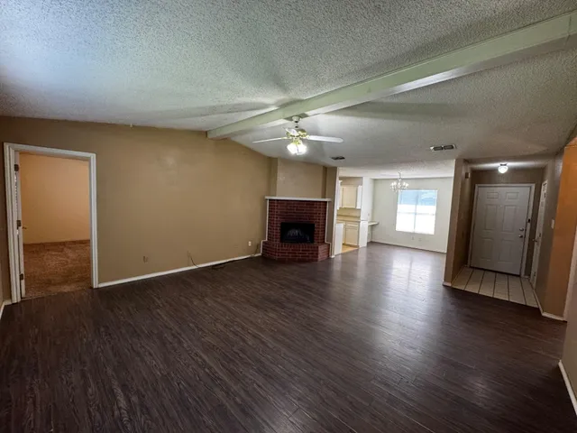 a view of a livingroom with wooden floor and a ceiling fan