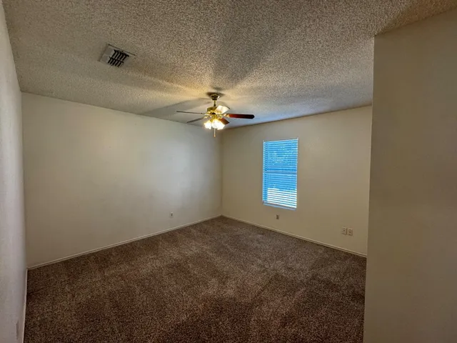 a view of room with window and ceiling fan