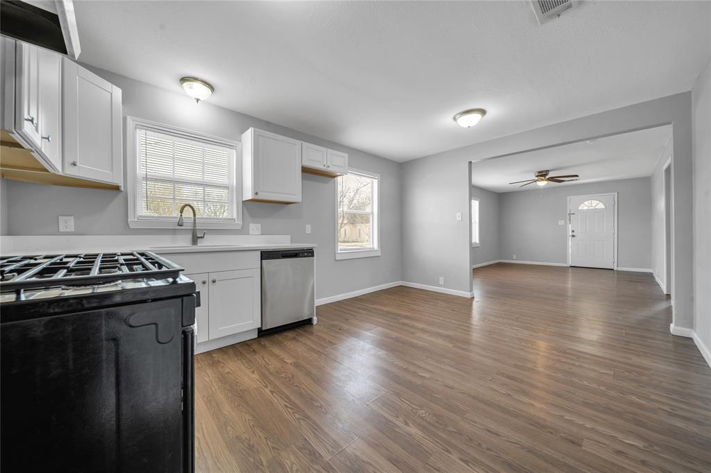 901 Johnson Street Terrell, TX 75160 - Photo 12 of 21 a kitchen with granite countertop a stove and a sink